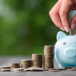 business finance and saving money investment , Money coin stack growing graph with hand putting coin on piggy bank saving concept. Balance savings and investment.