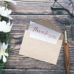 What To Include in a Wedding Thank You Card Thank You Letter On Wooden Table With Different Things New Backg