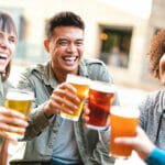 Intermittent Fasting, Binge Drinking, And More: What Is Up With America’s Young Generation Group of happy multiethnic friends drinking and toasting beer at brewery bar restaurant - Beverage concept with men and women having fun together outside
