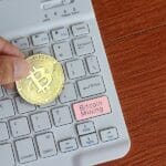 Hand Holding Bitcoin And Keyboard With Text Bitcoin Mining. Cryp