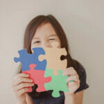 Young girl holding puzzle jigsaw, child mental health concept, world autism awareness day, autism spectrum disorder awareness concept