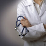 Doctor with a stethoscope in the hands behind the back
