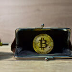 USB cable connects to crypto wallet. Crypto and bitcoin wallet concept. ryptocurrency trading exchange. BTC mining and investing concept. Blockchain and financial technology.