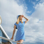 The Complete Guide to Chartering a Luxury Yacht: Everything You Need to Know Woman Sailor Stands On Deck Yacht With Striped Dress And Cap Loo