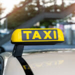 Close-up Detail Yellow Taxi Symbol On Cars Roof Stand Waiting At