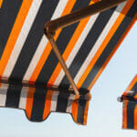 Why adding a Freestanding Retractable Awning will Perfect your Home? Folding patio balcony awning, side sun shade under bright summer sky