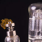 Macro detail of dabbing tool with small piece of cannabis oil ak