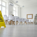 Why a Summer School Kitchen Clean is a Must School classroom where cleaning service worker placed sign which reads Caution Wet Floor
