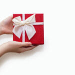 How to Send a Great Gift to Your Long Distance Partner Red Gift Box In Human Hands On A White Background. Beautiful Gif