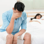 Incredible Ways of Treating Erectile Dysfunction Husband unhappy and disappointed in the erectile dysfunction during sex while his wife sleeping on the bed. Sexual Problems in Men.