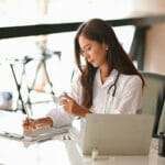 Dental Marketing: An Effective Approach A Female Dentist Writing A Dental Medicine Prescriptions On Digi