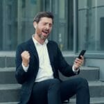 Why Everyone Switches to Earbuds – Top Secrets? Carefree Middle Aged Businessman In Wireless Earbuds Choosing Mu