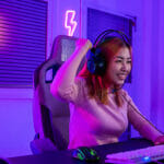 The Painted Wastelands: The Most Unique Roleplaying Game Adventure Winning. Young woman in gaming headphones playing video game online at home neon room feel excited, Happy Gamer young plays online video games computer she raises hands to wins tournament, E-Sport