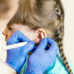 How to Pick the Best Ear Piercing for Kids A Charming Little Girl Is Undergoing The Procedure Of Ear Pierci