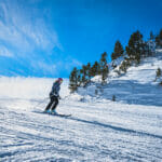 Woman Skiing Down The Ski Slope Or Piste In Pyrenees Mountains.