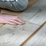 Floored Planning: How To Tell When It's Time To Replace Your Flooring A Man Lays A Laminate Floor. Repair In The Apartment. Laminate F