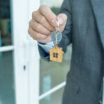 lease, rental and selling home. Real estate agent manager holding key for new owner. rent house, Sales, loan credit financial, insurance, Seller, dealer, installment, buy, sell, move in