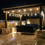The Ultimate Guide to Renting Your Dream Property: Tips for Property Managers A Resort Style Backyard At Night With A Waterfall, Pergola, And