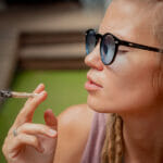 What Are Hemp Cigarettes? How Useful Are They? Hippie Style Woman Smoking Cigarettes With Medical Marijuana