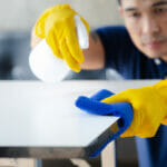 Person Cleaning The Room, Cleaning Staff Is Using Cloth And Spra