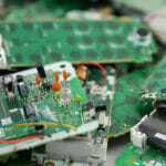 The Environmental Crisis of Electronic Waste: R2 Recycling's Crucial Role in Responsible E-Waste Management Telephone Circuit Board Parts Are Being Disassembled As Electron