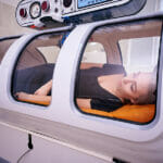 Is Oxygen Therapy Effective for Correcting Sleep Disorders? A Girl In A Black T-shirt Lies In A Hyperbaric Chamber, Oxygen T