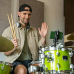 Man Records Drum Lesson On Phone And Shows Playing Technique