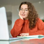 Young Pretty Woman Student Using Laptop Elearning Or Remote Work