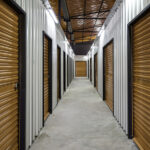 Corridor Of Self Storage Unit With Red Doors. Rental Storage Uni