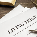 Living Trust Papers With Pen And Book.
