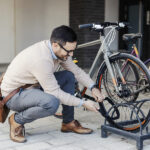 Why is Bike Lock Necessary A Smiling Urban Businessman Locking Up A Bike On The Street.