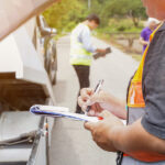 Closeup And Crop Insurance Agent Writing On Clipboard While Exam