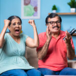 Happy Excited Indian Senior Couple Watching Live Cricket Sports