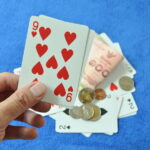 Close Up Of Hand Holding Nine Card In Baccarat Games