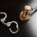 What Are the Key Factors in Choosing a Local Criminal Defense Attorney? Real Judges Gavel And Handcuffs On The Black Table