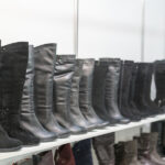 Boot Shopping 101: Tips for Finding Comfortable and Stylish Pairs Womens Boots On The Shelves In The Store. Pavilion Of The Store