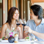 A young Asian couple having dinner at a restaurant