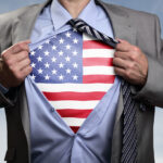 7 Fashionable Ways To Wear Men's Patriotic Shirts Businessman in classic superhero pose tearing his shirt open to
