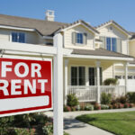 Right Facing Red For Rent Real Estate Sign in Front of Beautiful