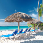 Beautiful caribbean beach with chaise lounge in Dominican Republ