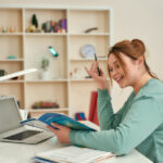 Woman Enjoying Study At Home. Side View Of Young Happy Female St
