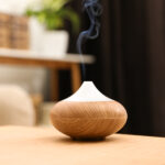 Aroma Oil Diffuser On Wooden Table At Home. Air Freshener