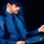 Unveiling the World of Online Private Investigators: A Guide to Combatting Sextortion, Blackmail, and Stalking Man with Hat and Pipe Looking at Laptop