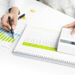 Market Analyze – pen and calculator on papers