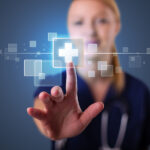 Pretty young nurse pressing modern medical type of buttons