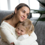 The Impact of Meeting Foster Care Criteria on Children's Lives Loving Single Mother Hugging Cute Little Daughter Showing Love C