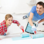 Common Mistakes to Avoid When Taking on House Painting Jobs repair, building and home concept – smiling couple painting wall