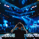 DJ with headphones at night club party under the blue light