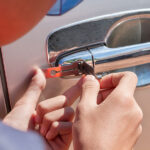 Top 7 Reasons Why You Might Need a Locksmith for Auto Close-up Of Person’s Young Man Locksmith Hand Opening Bronze Car