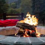 Outdoor Fireplace With A Bright Yellow Flame In A Fire Pit And A